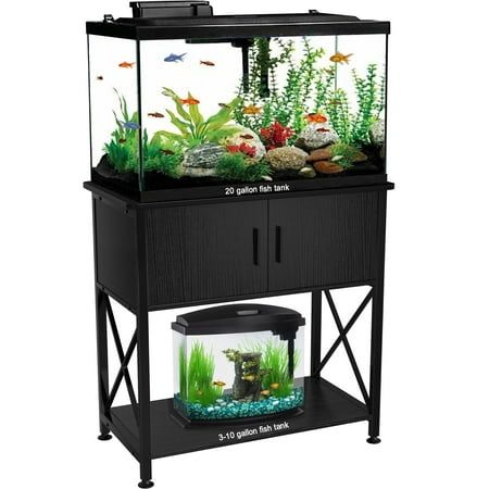 an aquarium with fish in it and plants on the bottom shelf, sitting on a stand