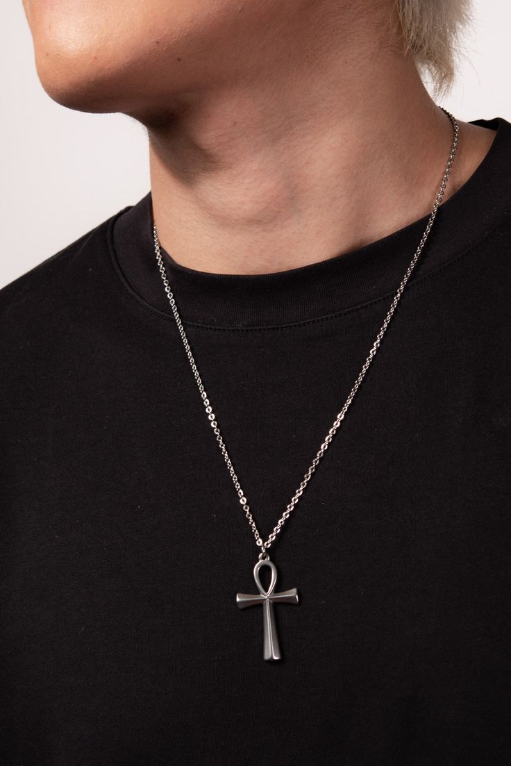 This Stainless Steel Chain Necklace with Ankh Pendant is the perfect blend of style and ancient symbolism. The Ankh pendant, an ancient Egyptian symbol of life, adds a touch of spirituality and cultural significance to this necklace. Whether you're looking to make a fashion statement or simply want to add a meaningful accessory to your collection, this necklace is a great choice. Plus, with its affordable price and versatile design, it makes a great gift for any friend or loved one. Size Length: Cheap Ankh-shaped Spiritual Necklaces, Ankh Necklace Men, Symbolic Metal Cross Necklace, Symbolic Stainless Steel Cross Necklace, Spiritual Metal Pendant Cross Necklace, Spiritual Metal Cross Pendant Necklace, Symbolic Cross Pendant Necklaces, Symbolic Stainless Steel Cross Pendant Necklace, Spiritual Metal Pendant Chain Necklace