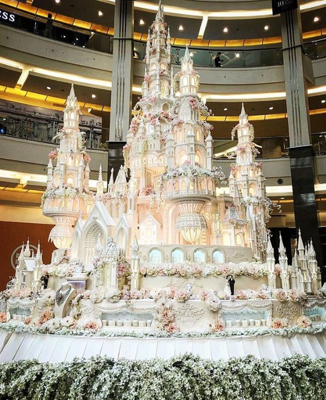 an elaborately decorated christmas tree in the middle of a building with lots of lights