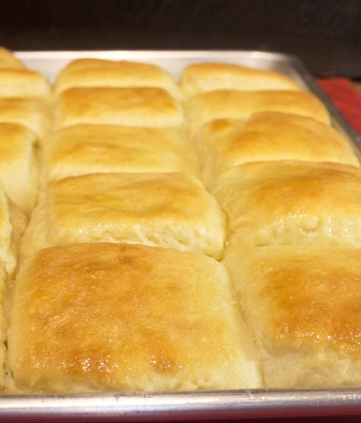 a pan filled with bread sitting on top of a red cloth next to a stove