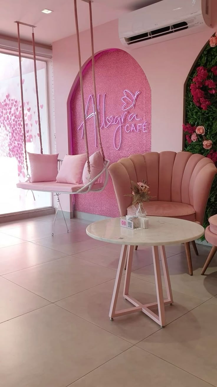 a room with pink furniture and flowers on the wall, in front of a sign that says happy girl