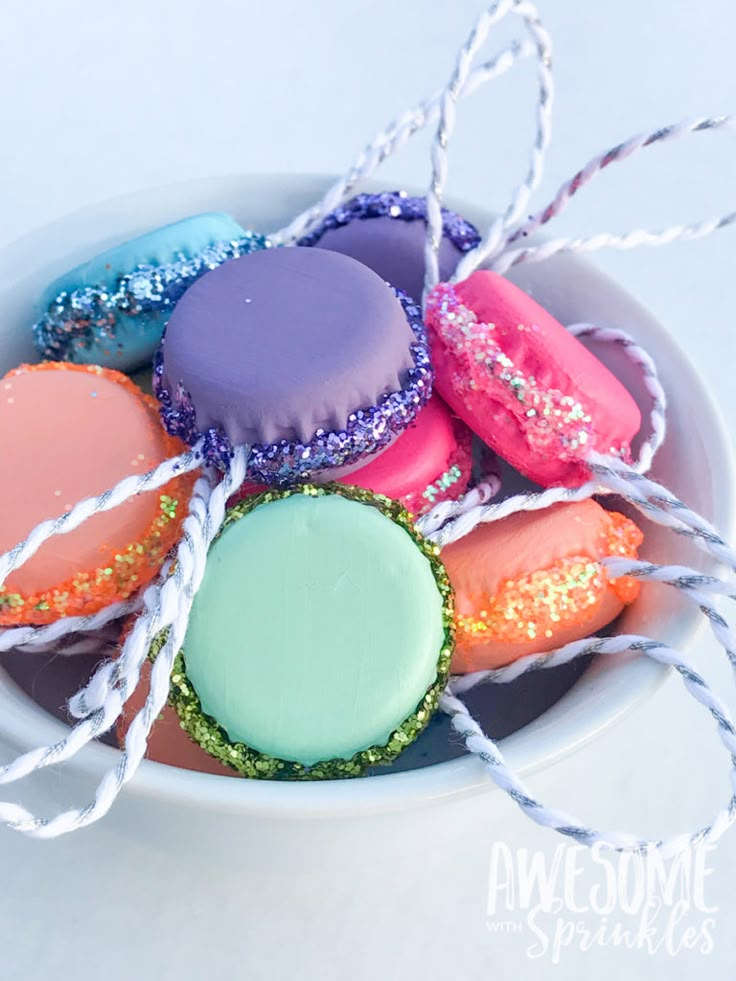 colorful macaroons in a white bowl with twine