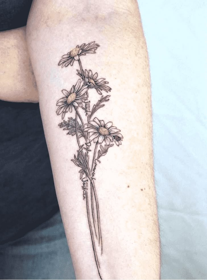 a woman's arm with daisies tattooed on the back of her left arm