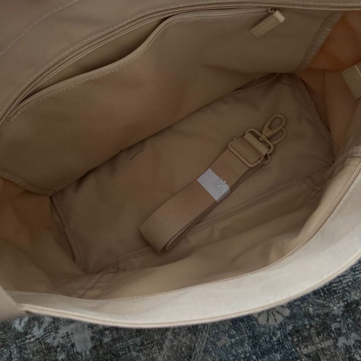 New, Never Used Beige Strap Included Dims: 20.75"L X 12.5"H X 6.25"D Material: Body : 100% Polyester Trim : 100% Pu Lining : Unlined Care: Spot Clean Weight : 1.8 Lbs Capacity : 32l Beige Canvas Bag With Adjustable Strap For Errands, Beige Duffle Bag For Daily Use With Large Capacity, Beige Large Capacity Tote Diaper Bag, Large Capacity Beige Duffle Bag For Daily Use, Large Capacity Beige Diaper Tote Bag, Cream Large Capacity Diaper Bag For Everyday Use, Cream Bucket Canvas Bag For Travel, Beige Satchel Weekender Bag With Large Capacity, Beige Shoulder Bag With Adjustable Strap For Travel