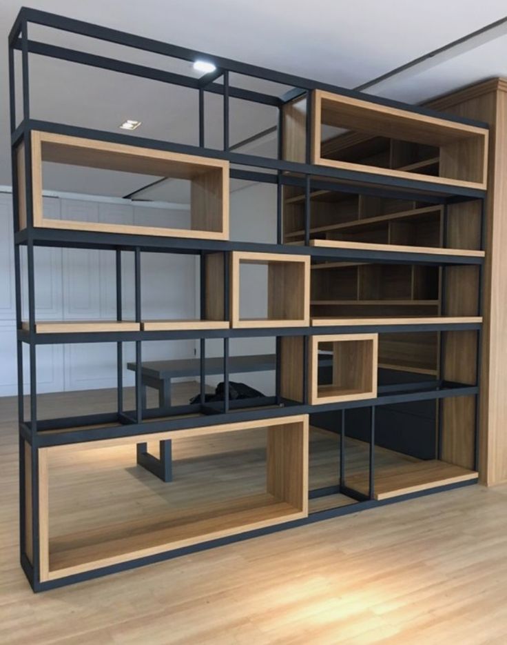 an empty room with shelves and desks in it