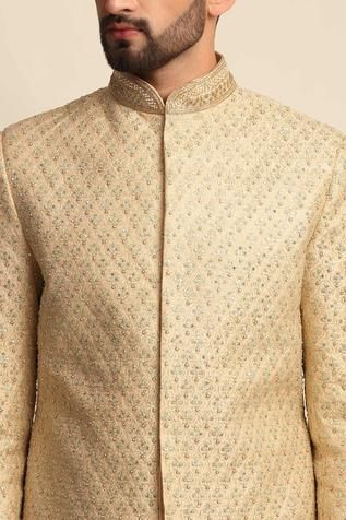 Golden sherwani with dori work embroidered motifs. Paired with front button placket kurta and straight-cut pant. Designer Festive Sets With Gota Work, Designer Churidar With Zari Work For Diwali, Designer Zari Work Churidar For Diwali, Gold Kurta With Dori Work For Reception, Designer Cutdana Kurta For Reception, Designer Churidar With Zari Work For Festive Season, Designer Festive Churidar With Zari Work, Designer Bandhgala With Gota Work For Diwali, Designer Churidar With Zari Work