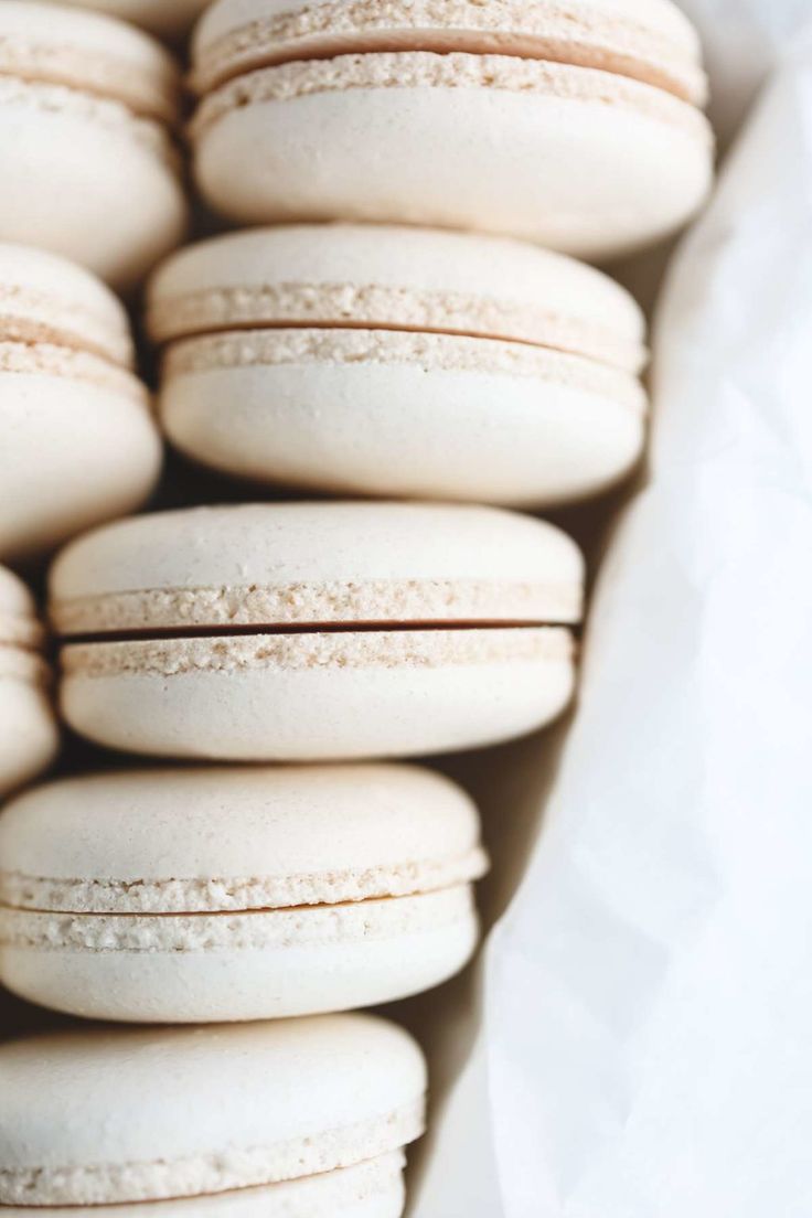 several white macaroons stacked on top of each other