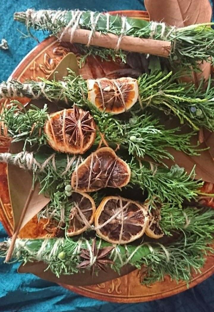 an arrangement of fruits and herbs on a plate