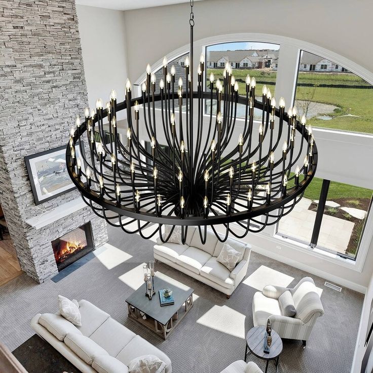 a large chandelier hanging from the ceiling in a living room