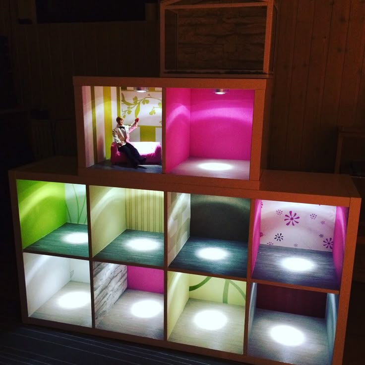 an illuminated room with several different colored lights on the walls and shelves in front of it