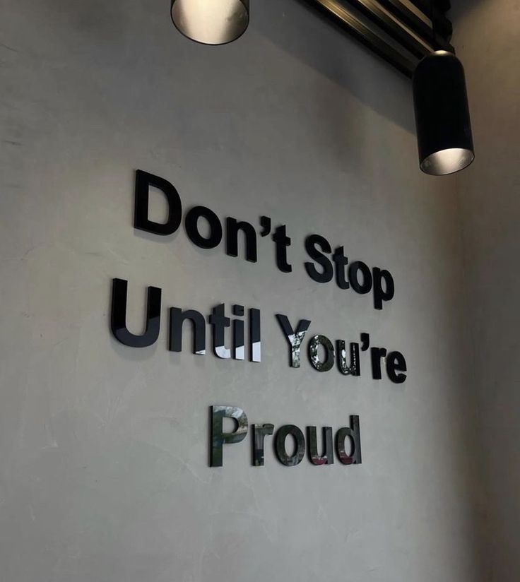 the sign on the wall says don't stop until you're proud