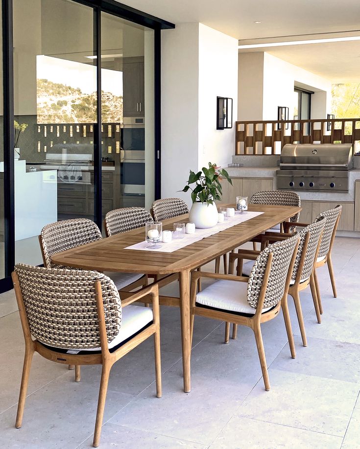 an outdoor dining area with table and chairs