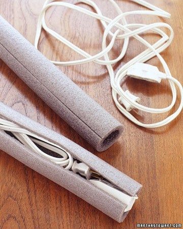 two wii motes sitting on top of a wooden floor next to wires and cords