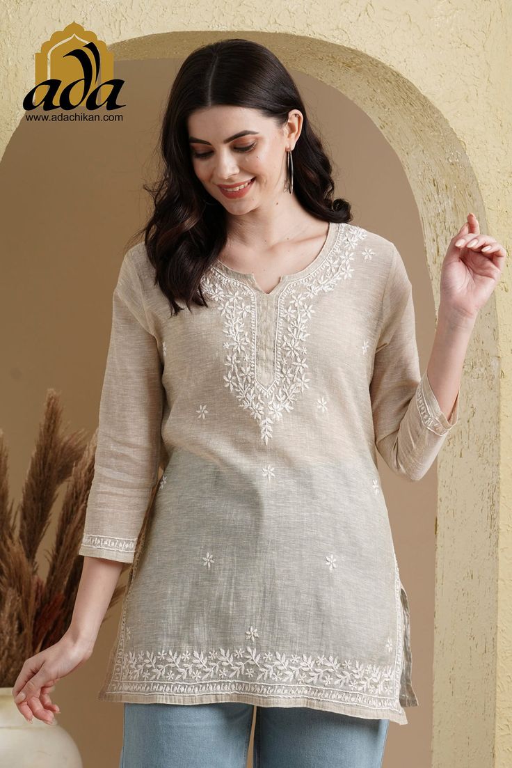 Find more items of ADA:- https://www.etsy.com/shop/ADAlucknow?ref=shop_sugg_market SKU: A911388 Color: Fawn Fabric: Khadi Cotton Length: 31 Inches Sleeves: Quarter Sleeves Neck: Notch Neck Slit Detail: N/A Embroidery:  "Murri, Phanda & Ghaspatti" Thread: Cotton Thread Color: White Touch and Feel: Soft and Comfortable Silhouette: A lively and cheerful top to light up your mood - perfect to wear to your office or at-home work setup. Detailed with Chikankari embroidery work on the yoke and hem with splashes of it on the back, this thigh-length top has three-quarter sleeves, notched neckline and a straight hem. Style it for your next weekend outing with colourful cotton drawstring waist pants and mules to complete the look. Disclaimer: This product is hand embroidered and may have slight dissi Khadi Kurti, Chikan Kurta, Short Kurti Designs, Khadi Kurta, Design Kurta, Rajasthani Dress, Churidar Neck Designs, Chikankari Embroidery, Kurta For Women