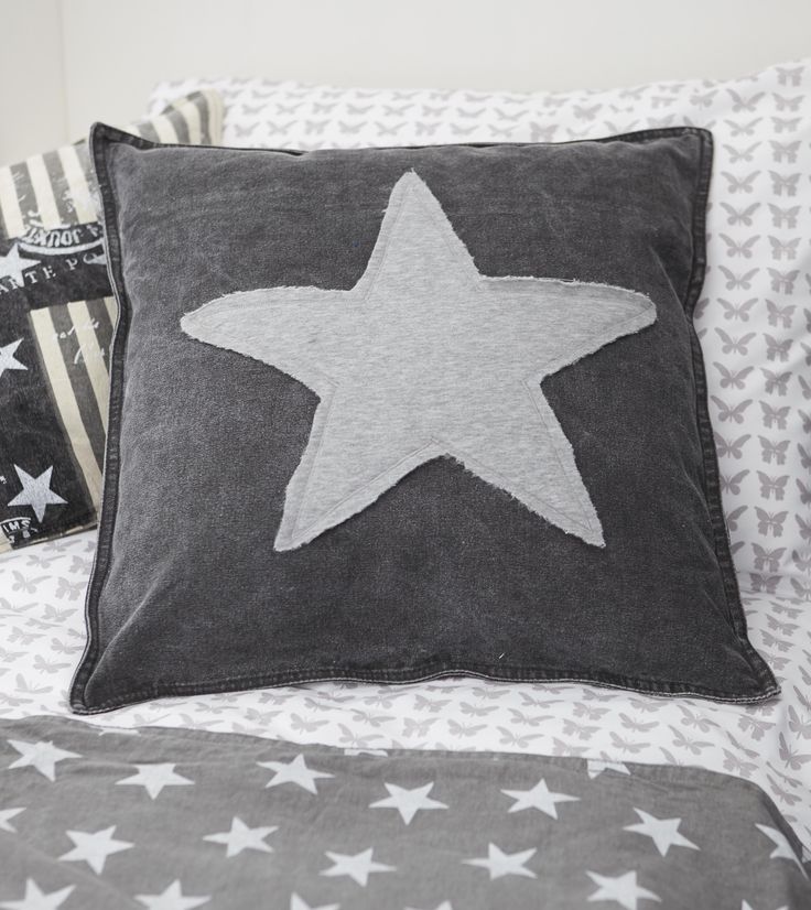 a star pillow on top of a bed