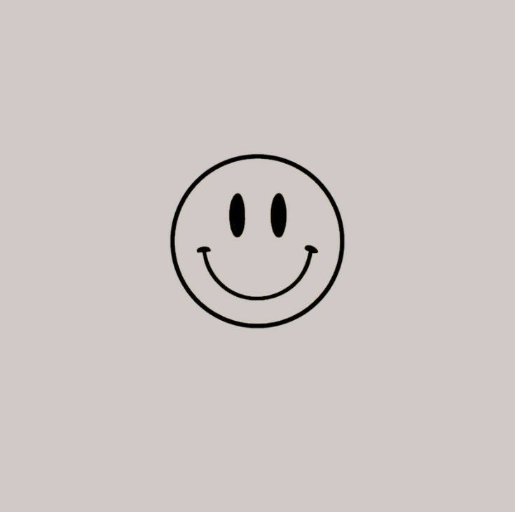 a black and white smiley face on a gray background