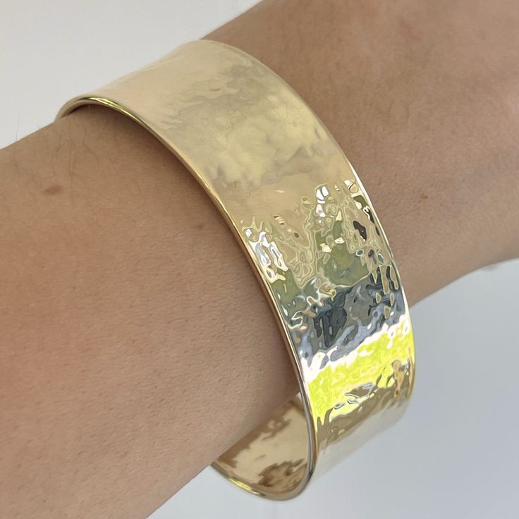 14KT polished yellow gold hammered + textured cuff bangle bracelet. An amazing. Italian-made, modern statement cuff to stack with more bangles. Open cuff; simply slide over wrist Fits most wrist sizes; adjustable size Width: 19mm 585/ 14kt purity Weight: 17g Made in Italy Luxury Stackable Bangle Cuff Bracelet, Luxury Modern Stackable Cuff Bracelet, Luxury Hammered Bangle For Women, Sterling Silver And Gold Hammered Cuff, Luxury Hand Forged Yellow Gold Bracelets, Luxury Gold Artisan Cuff Bracelet, Luxury Yellow Gold Sterling Silver Bangle Bracelet, Luxury Handmade Brass Cuff Bracelet, Luxury 22k Gold Hammered Jewelry