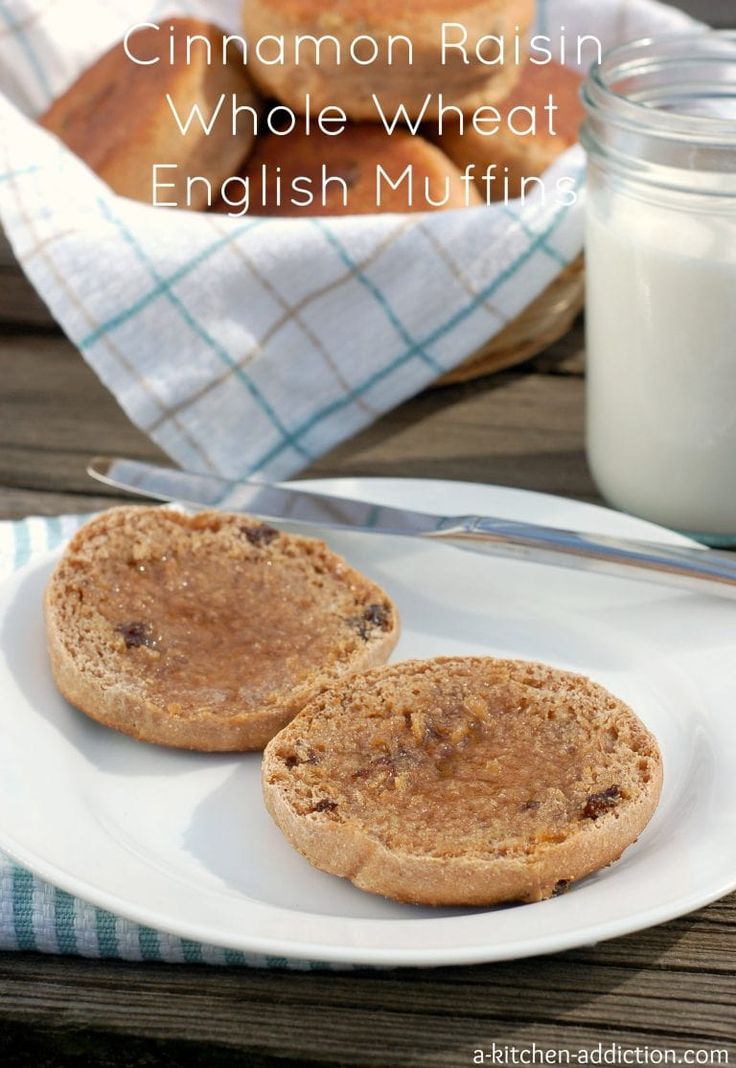 cinnamon raisin whole wheat english muffins on a white plate next to a jar of milk