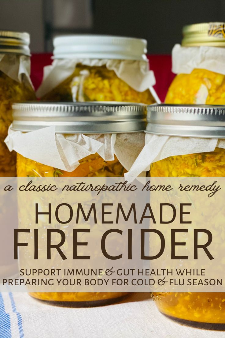 three jars filled with homemade fire cider sitting on top of a table