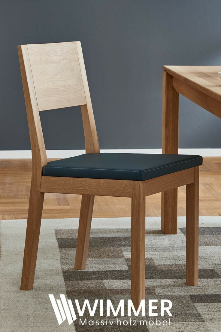 a wooden chair sitting on top of a carpeted floor