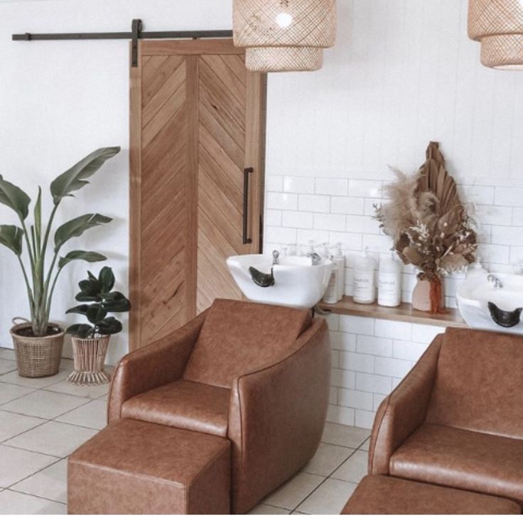 two brown chairs sitting next to each other in a bathroom