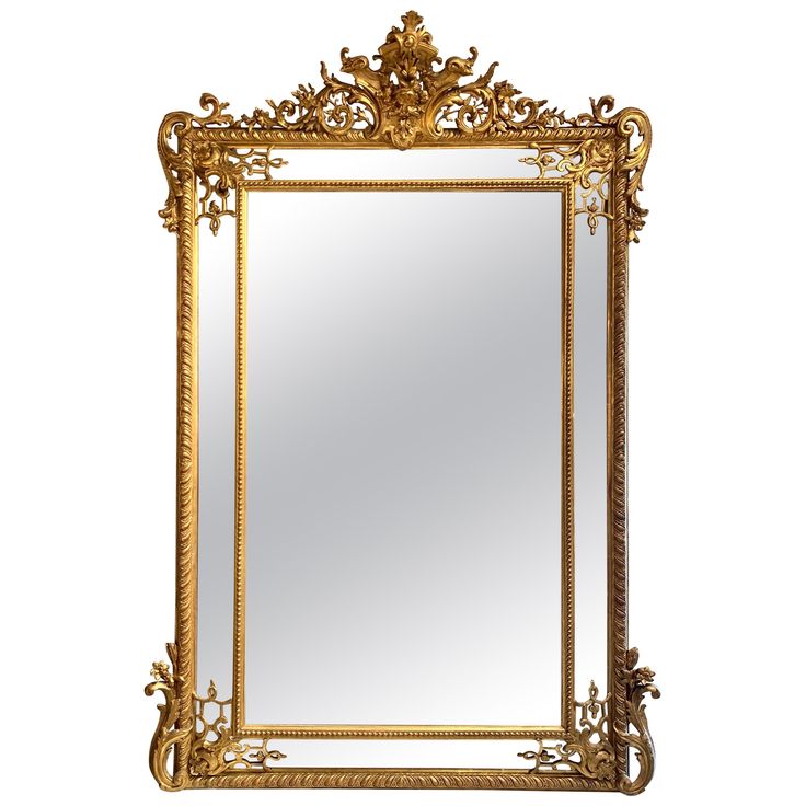 an ornate gold framed mirror against a white background