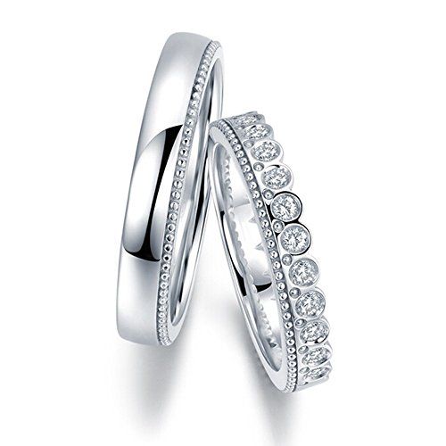 two white gold wedding rings with diamonds on each one and the other in between them