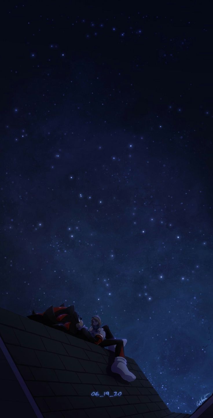 two people sitting on the roof of a building at night with stars in the sky