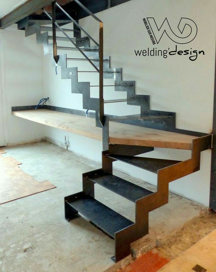 a set of metal stairs in an unfinished room