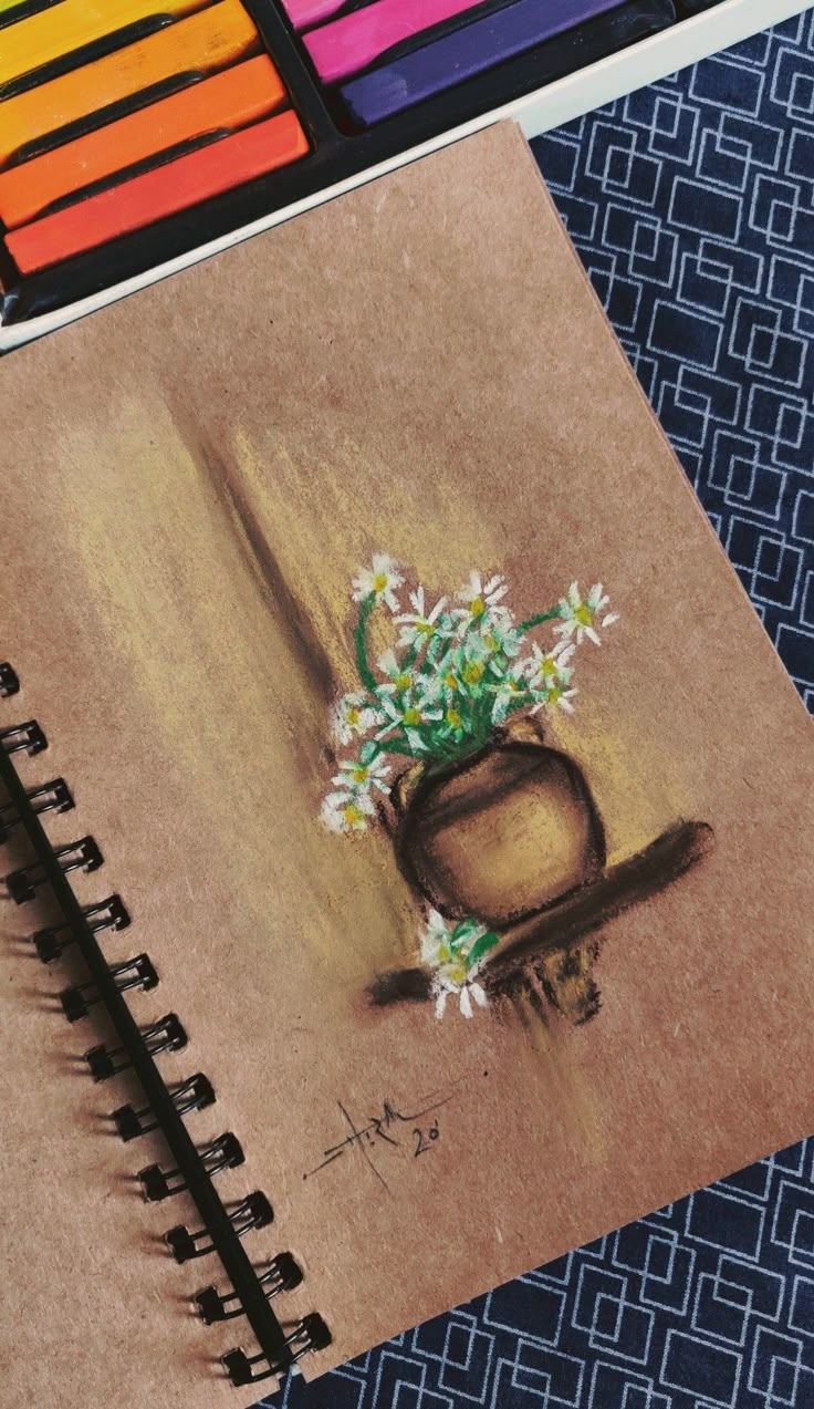 a drawing of a vase with flowers in it and colored pencils next to it