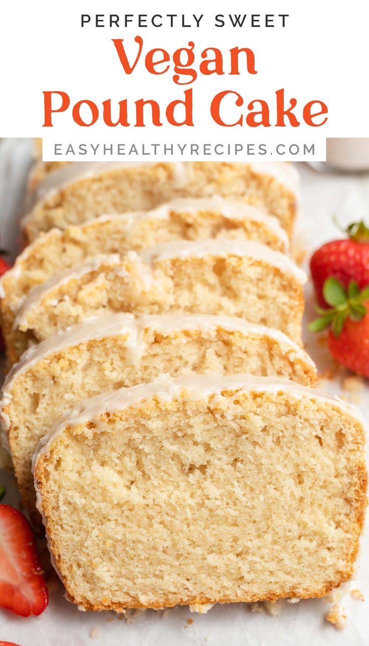 sliced loaf of vegan pound cake with icing and strawberries on the side