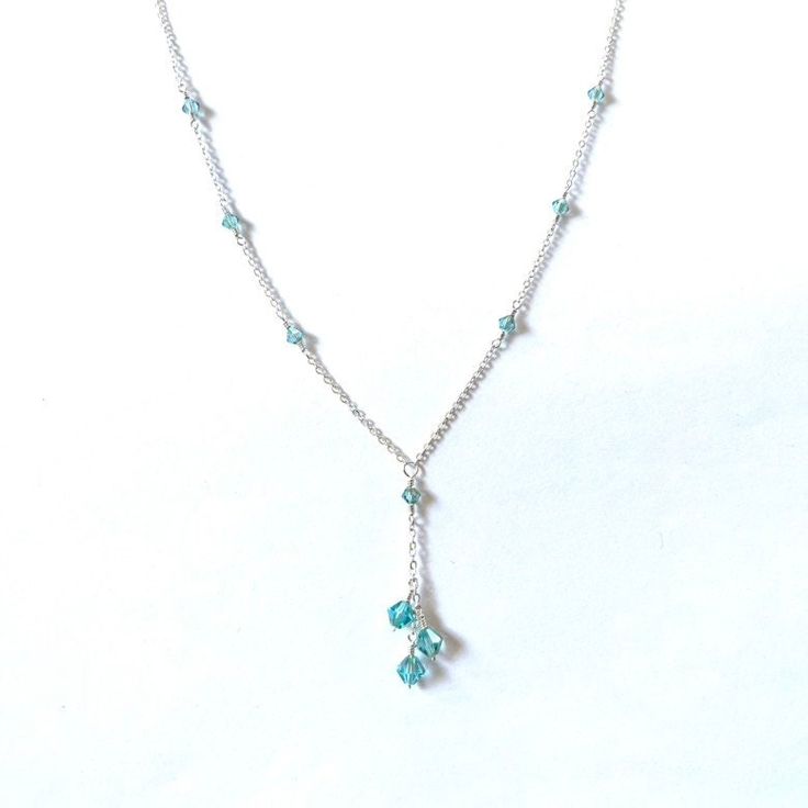 Three beautiful aqua with purple haze bicone crystals cascade down a delicate silver plated chain with matching crystal accents. Available with gold plated or gunmetal grey chain upon request. Silver Drop Crystal Necklace With Adjustable Chain, Elegant Light Blue Beaded Chain Jewelry, Elegant Light Blue Beaded Jewelry, Elegant Blue Dangle Crystal Necklaces, Elegant Silver Crystal Necklace With Dangling Beads, Elegant Light Blue Necklace With Beaded Chain, Silver Crystal Dangle Lariat Necklace, Silver Crystal Lariat Necklace With Dangle, Gunmetal Grey