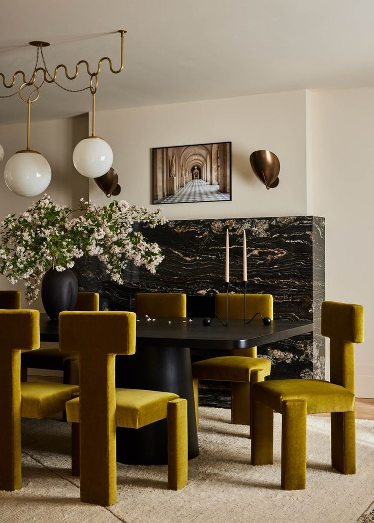 a dining room with yellow chairs and a black table