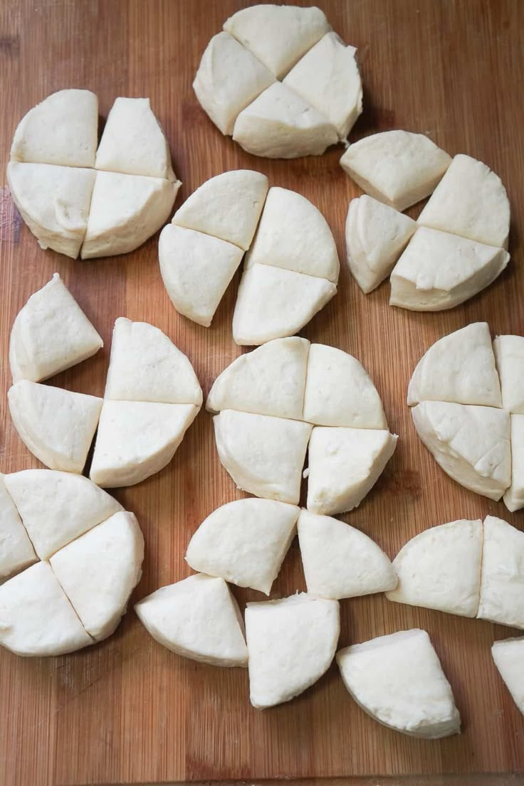 several pieces of cheese are cut up on a cutting board and ready to be cooked