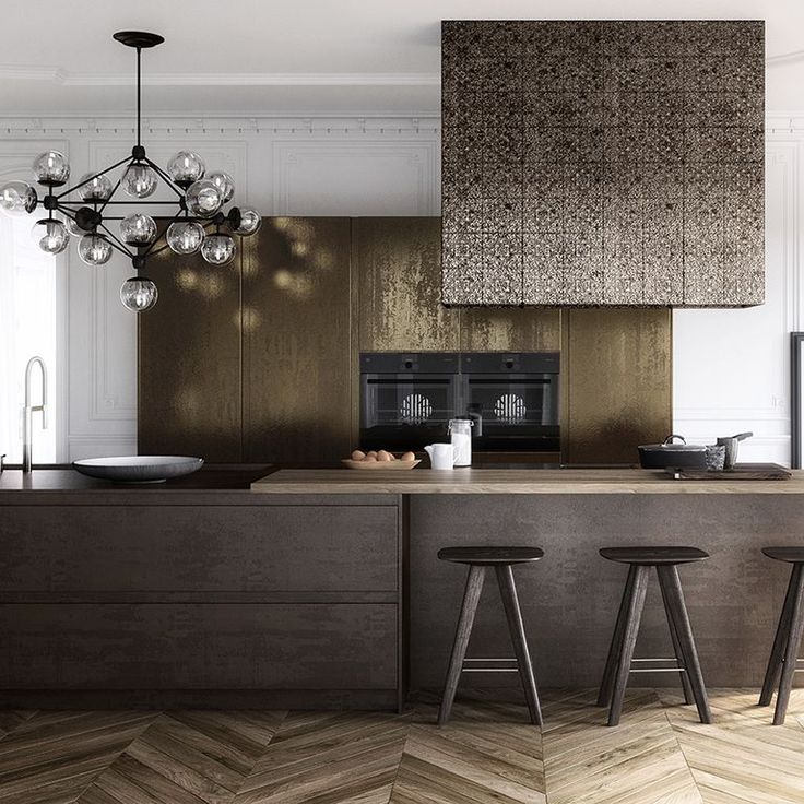 a kitchen with two stools next to an island