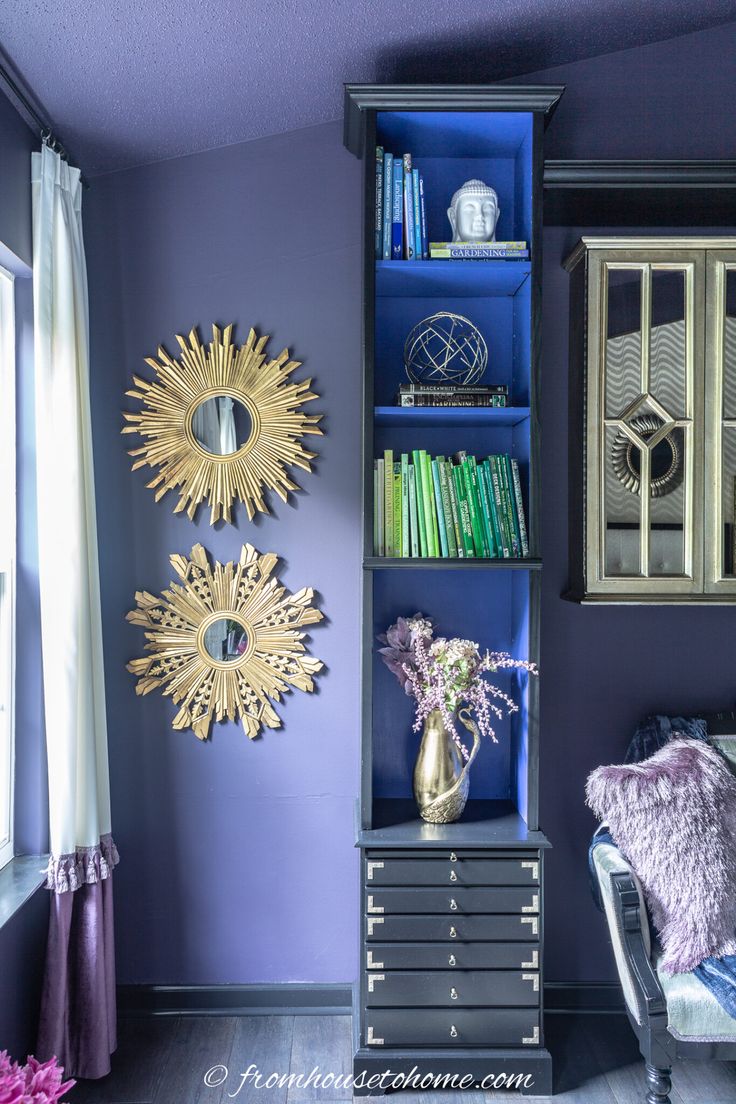 A narrow blue and black bookshelf in a purple room Dark Purple Bedroom Walls, Dark Purple Bedroom, Purple Bedroom Walls, Blue Bookshelf, Purple Spray Paint, Blue Bookshelves, Blue Home Offices, Dramatic Bedroom, Bookshelf Makeover