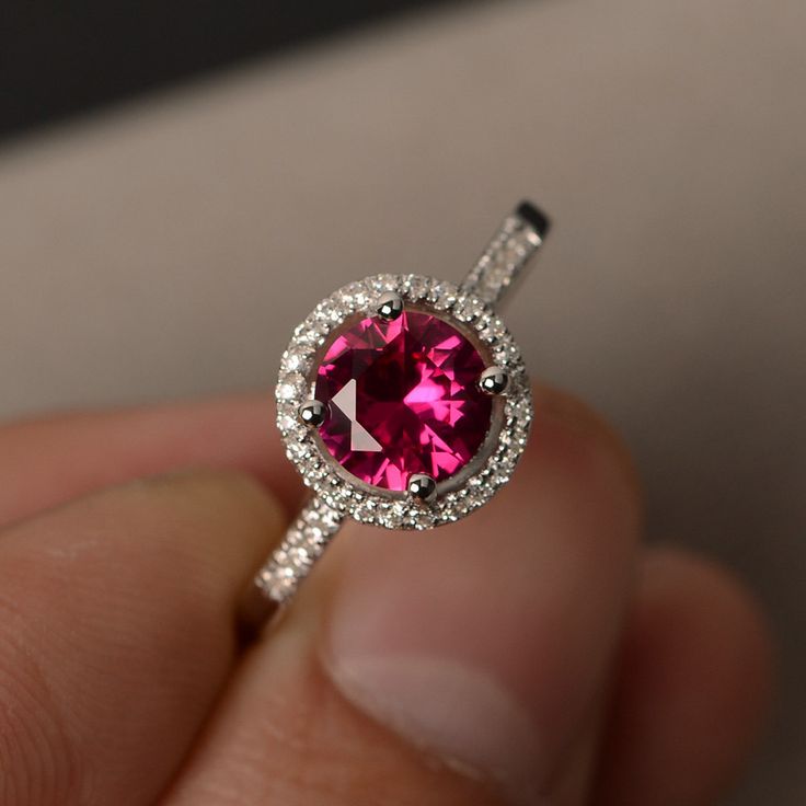 This is a gorgeous handmade creation. Its beauty is its simplicity & Elegance. The 7*7mm round cut lab created ruby is crafted in solid sterling silver and with rhodium plated. All item is sent in a beautiful gift box You can realize more lovely stuff clicking the link https://www.etsy.com/shop/knightjewelry?refshopsection_shophome_leftnav Please leave the correct address and you phone number for delivering successfully. Sterling Silver Ruby Ring With Center Stone, Classic Round Cut Lab-created Ruby Jewelry, Classic Ruby Ring With Halo Setting Gift, Classic Ruby Ring With Halo Design As Gift, Diamond Ring With Center Stone And Lab-created Ruby, Classic Round Crystal Birthstone Ring, Classic Pink Ruby Ring In Sterling Silver, Cubic Zirconia Ruby Ring With Halo Design, Elegant Round Garnet Crystal Ring