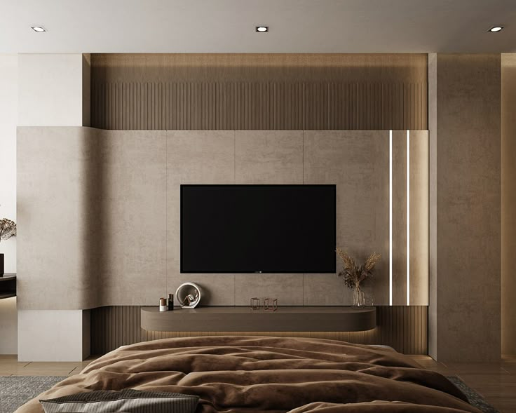 a large flat screen tv mounted to the side of a wall next to a bed