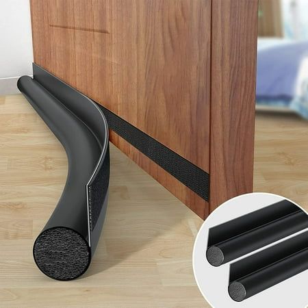 an image of a black door stopper on the floor next to a wooden cabinet