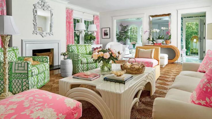 a living room filled with lots of furniture next to a fire place in a house