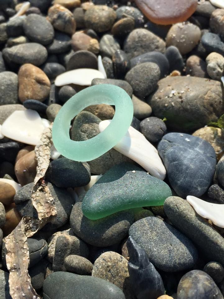 a green ring sitting on top of some rocks