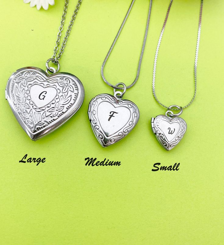 "This is a unique engraving initial on stainless steel heart locket charm on 18 inches stainless steel necklace chain.  I do not put the photo to the locket HOW TO ORDER 1) Select the quantity 2) Select stamp the initial and style  3) Add to cart DESCRIPTION ♥ Necklace, Stainless Stee Chain with Lobster Claw Clasp, Size: about 17.7 inches (45cm) long, 1-2mm wide, Nickel Safe, ♥ LARGE, 304 Stainless Steel Locket Pendants, Photo Frame Charms for Necklaces, Heart, Platinum, Size: about 29mm (1 1/8\") wide, x 29mm (1 1/8\") long, 7mm thick; Fits photo 21mm or 7/8\" (W)x17mm or 5/8\"(H) OR ♥ MEDIUM, 316 Stainless Steel Locket Pendants, Photo Frame Charms for Necklaces, Heart, Stainless Steel Color, Size: about 0.77-inch(19.5mm) wide, 0.89-inch(22.5mm) long, 0.20-inch(5mm), inner (fit photo) dia Initial Pendant Locket Necklace With Charms As Gift, Heart Charm Locket Necklace Gift, Valentine's Day Gift Locket Necklace With Initial Pendant, Engraved Heart Pendant Locket Necklace As Gift, Engraved Heart Pendant Locket Necklace, Engraved Heart Locket Necklace, Personalized Gift, Engraved Heart Locket Necklace For Personalized Gift, Engraved Heart Locket Necklace For Mother's Day, Silver Locket Necklace For Gift