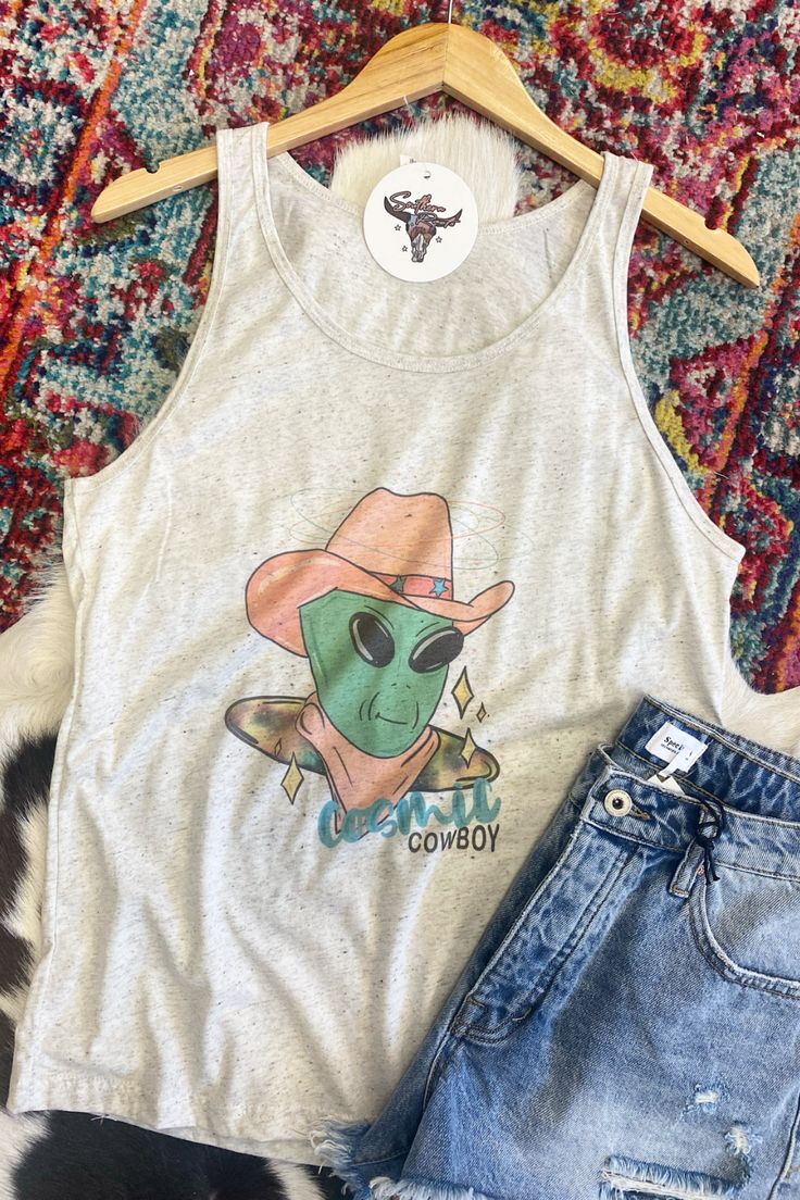 See you in space! How fun is this cosmic cowboy tank?? This tank is a flowy fit and would be such a fun addition to your summer wardrobe! We love how lightweight this tank is, it's perfect for those hot summer days! lightweight flowy 50% polyester, 25% cotton, 25% rayon Southern Roots Boutique112 W. Main St. Paragould, AR *Please allow 5-7 business days processing time for this item to be shipped/picked up. Trendy Graphic Print Vest For Summer, Trendy Graphic Print Summer Vest, Casual Spring Vest With Graphic Print, Casual Graphic Print Vest For Spring, Fun Sleeveless Tank Top For Spring, Trendy Racerback Vest For Spring, Trendy Tank Vest For Summer, Casual Tops For Summer Music Festival, Trendy Summer Tops For Music Festival