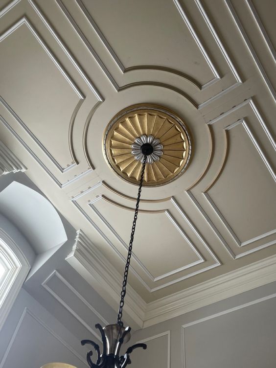 a chandelier hanging from the ceiling in a room with white walls and ceilings