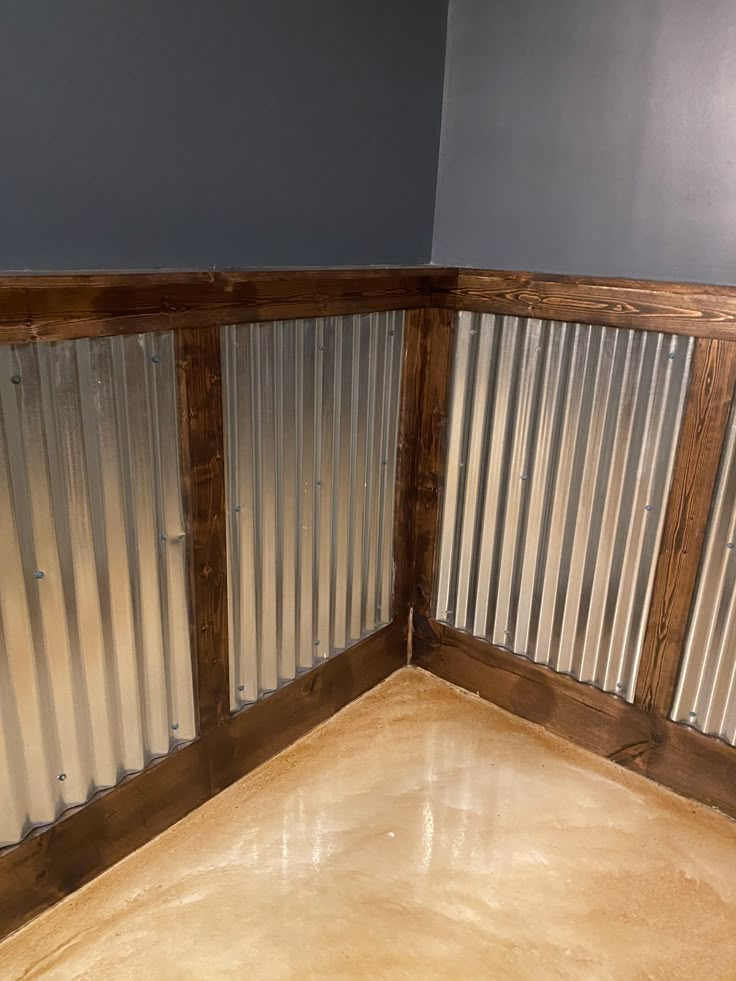 the corner of a room with metal slats on the wall