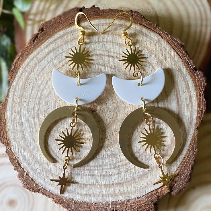 Handmade lightweight crescent moon, sun and star earrings, with brass charms and white polymer clay moons, on 18k plated ear wires🌙 Length: 9 cm  More beautiful jewelry can be found in my shop:  https://www.etsy.com/dk-en/shop/ONCEUPONAPOTIONDK?ref=seller-platform-mcnav§ion_id=21367729 Should you have any questions please feel welcome to send me a message✨ White Celestial Nickel-free Jewelry, Celestial White Nickel-free Jewelry, Handmade White Celestial Jewelry, Adjustable White Jewelry With Sun And Moon Design, White Moon Shaped Celestial Jewelry, White Bohemian Jewelry With Sun And Moon Design, White Moon-shaped Celestial Jewelry, White Half Moon Celestial Jewelry, White Celestial Moon Jewelry