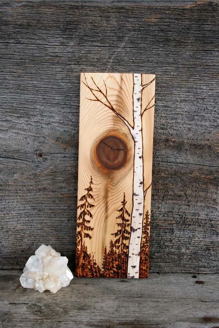 a piece of wood with trees on it