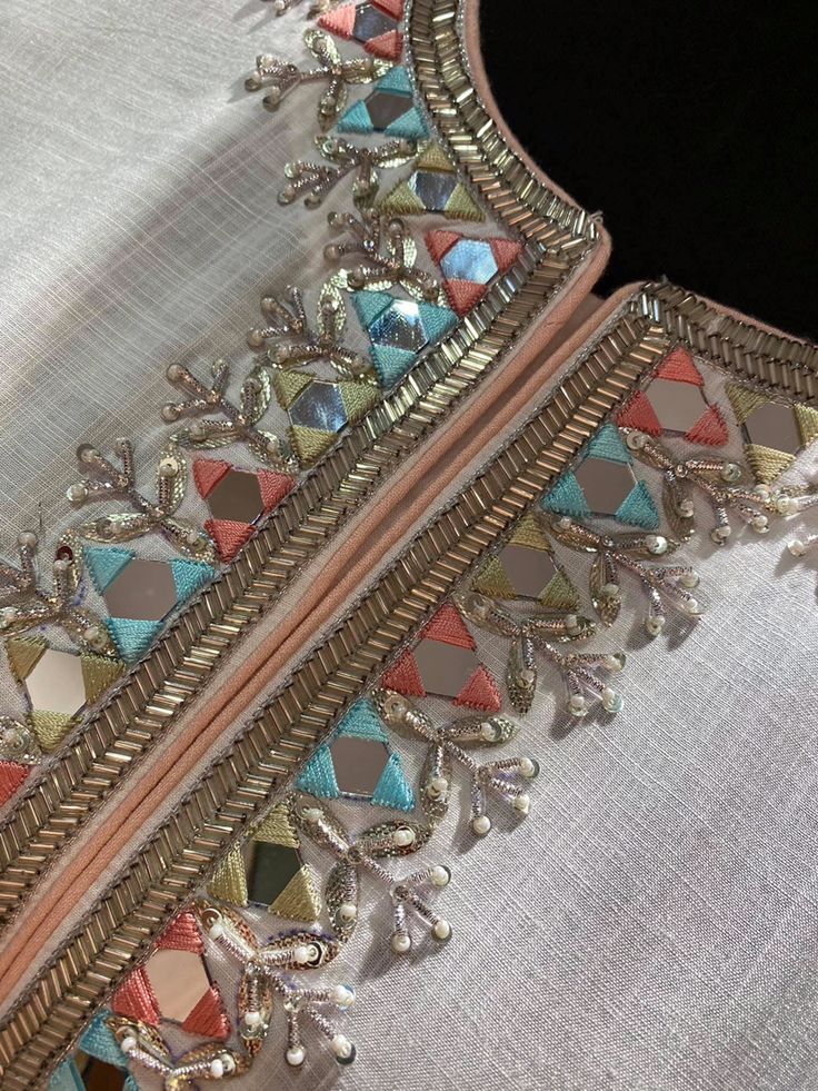 a close up of a piece of cloth with beading and beads on the edge