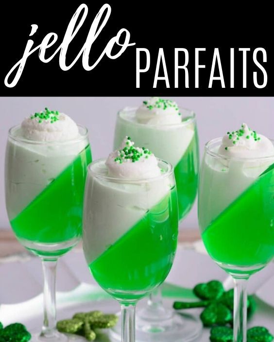 three glasses filled with green jello and topped with whipped cream, sprinkles