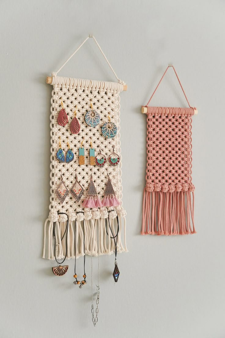 two wall hangings with earrings on them